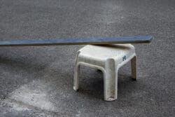 Blue wooden board on white plastic stool